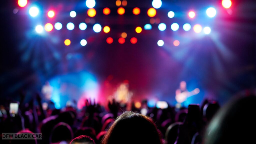 Group of friends enjoying a live concert in Dallas-Fort Worth, celebrating with music and lights before riding home in a luxury limousine from DFW Black Car & Limo.