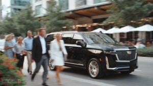 Elegantly dressed group of friends in walking away from a sleek black chauffeured Cadillac Escalade SUV on a city street at dusk, evoking luxury transportation and nightlife sophistication.